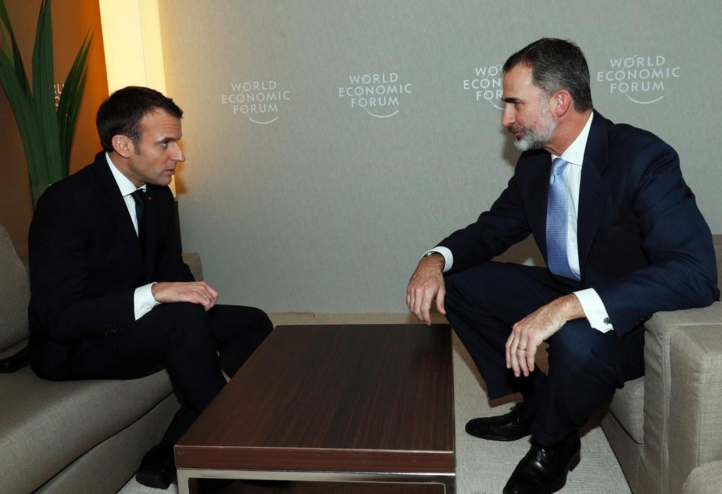 French President Emmanuel Macron sits together with King Felipe VI of Spain