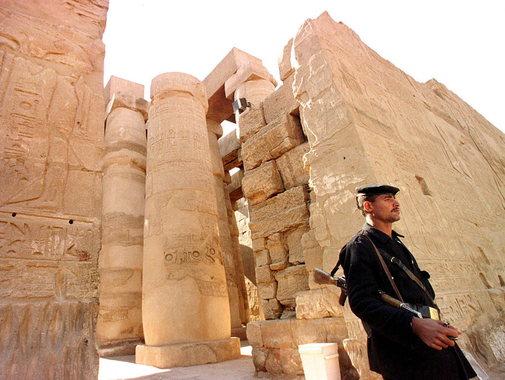 A soldier stands in front of a temple in Luxor