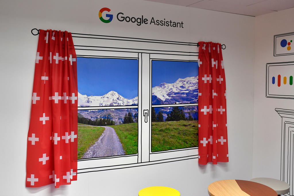 A wall of a Google office painted like a window, looking at a Swiss landscape