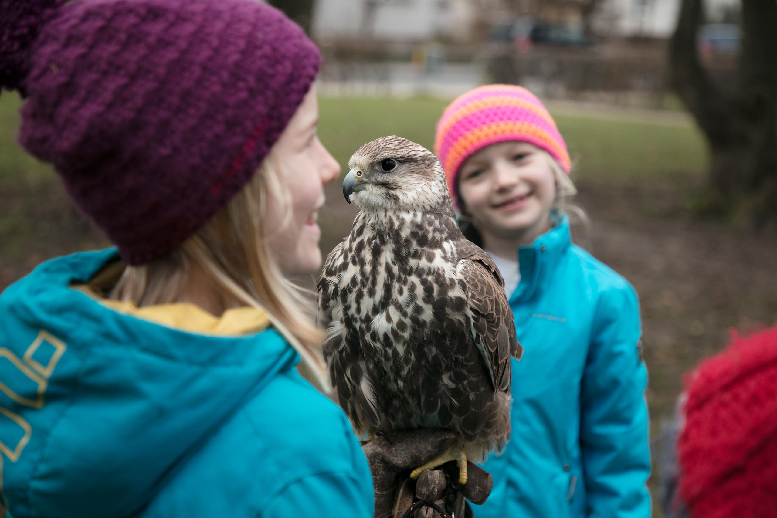 Two young girls with a bird of prey.