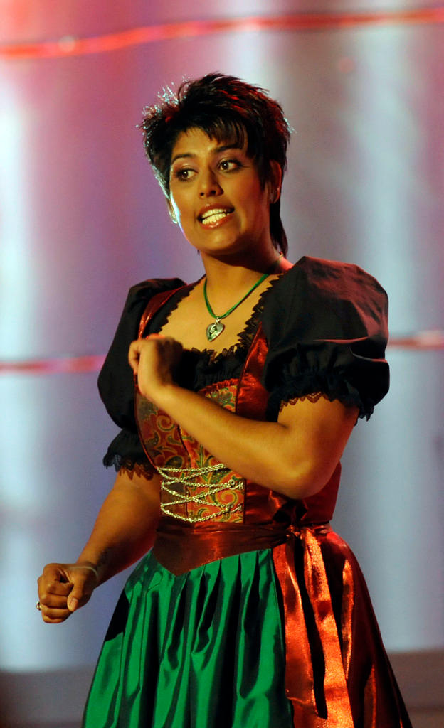 A young woman, singer Sarah-Jane, who was adopted from India, wearing a dirndl