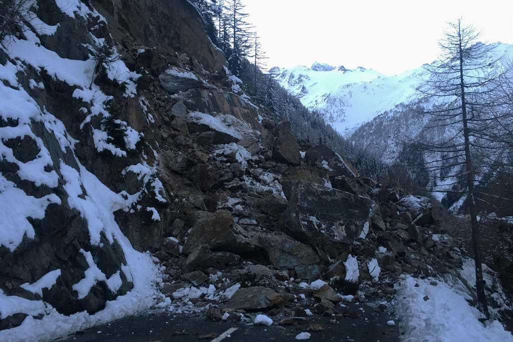 Rocks cover a small road