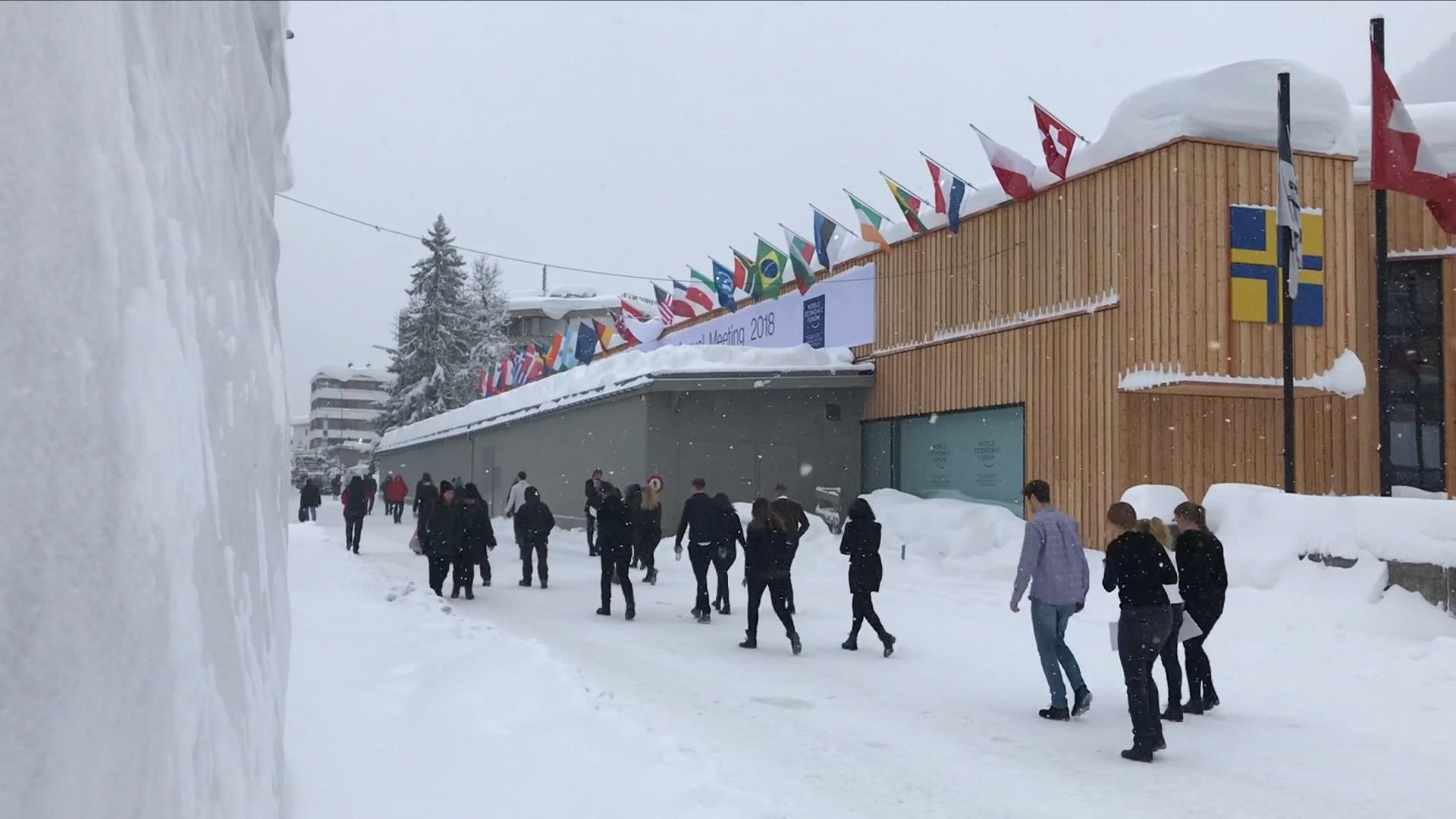 people traipsing through snow to conference