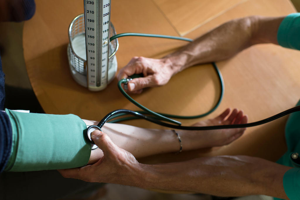 A doctor takes a patient s blood pressure