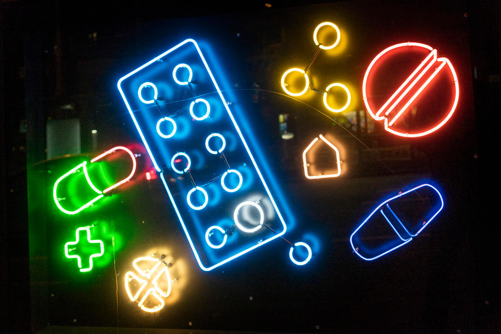 Fluorescent tubes formed into pills and medicines in the shop window of a pharmacy