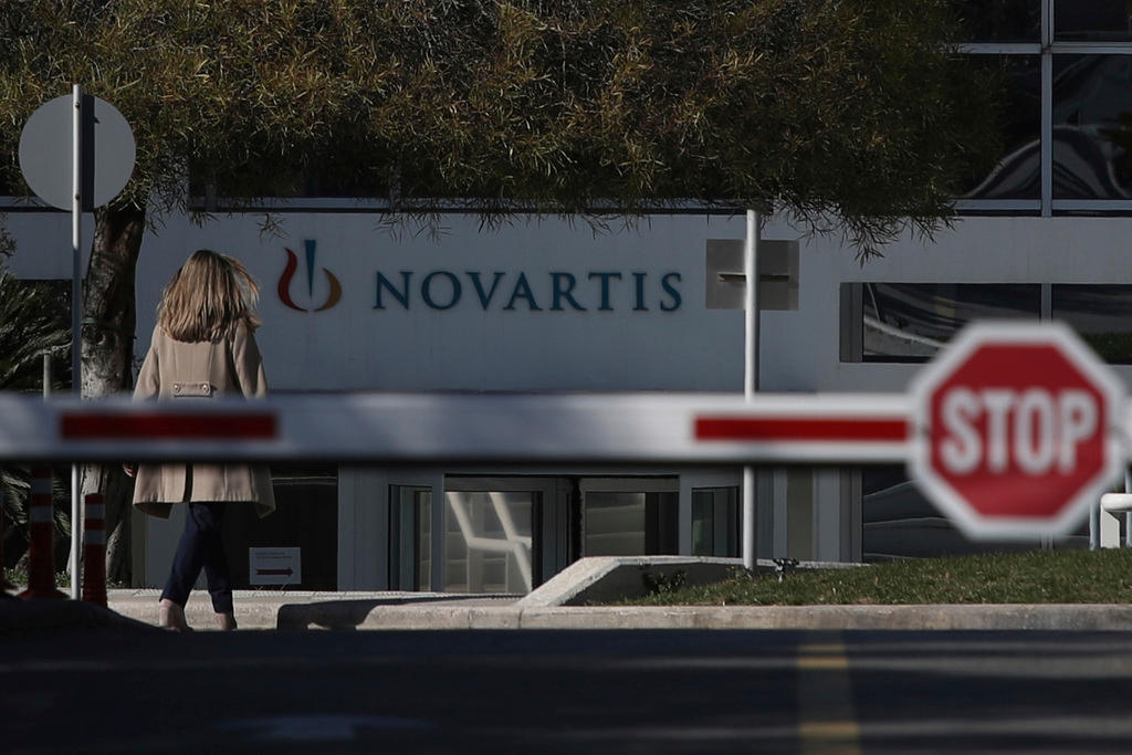 A woman enters Novartis Greek offices in Athens, on Tuesday, Feb. 6, 2018.