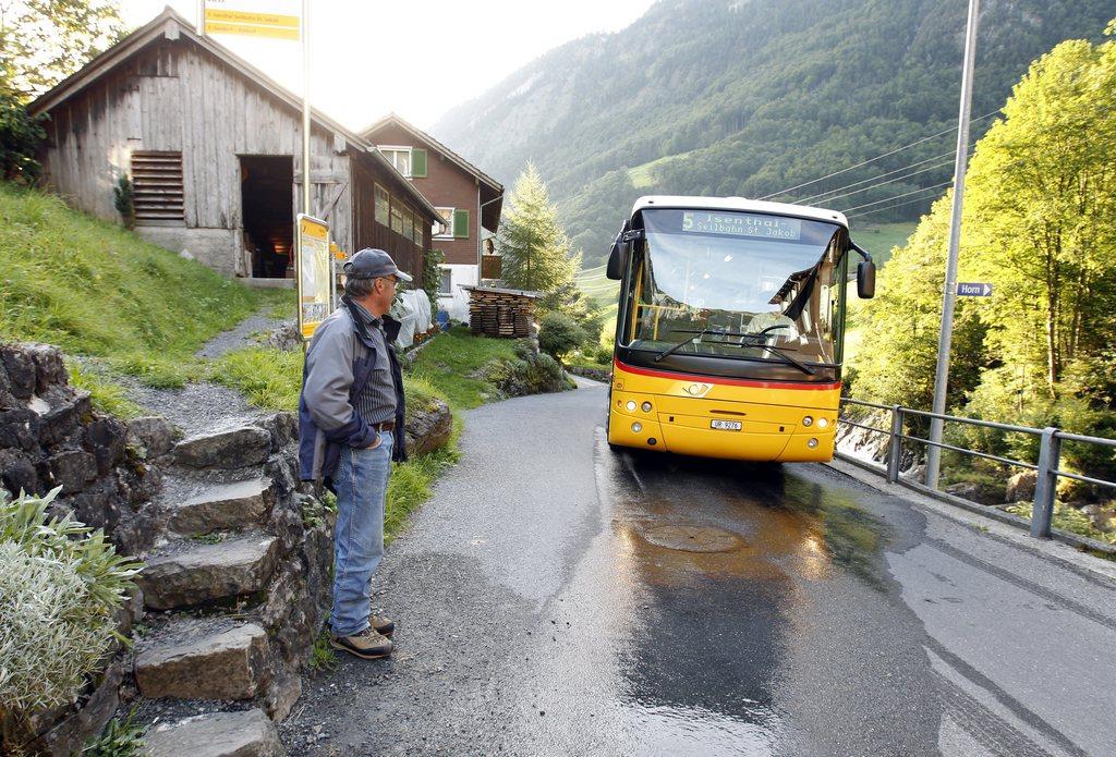 A PostBus climbs the Altdorf-Isenthal road in canton Uri