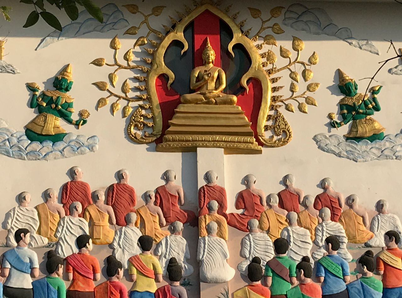 A mural of people praying in Laos