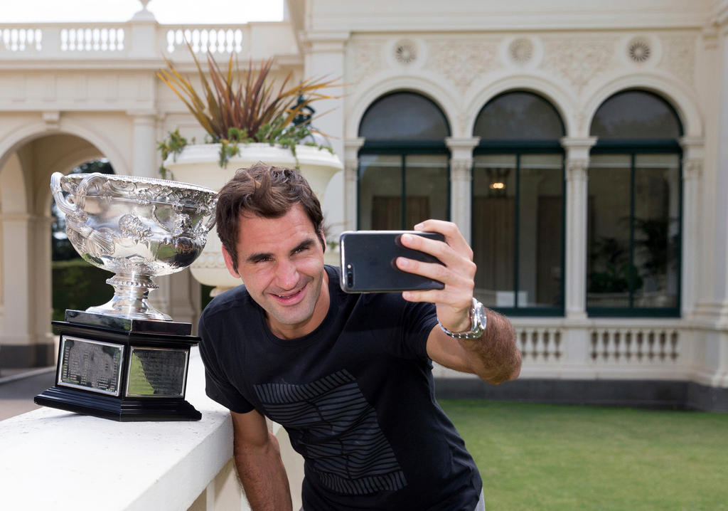 Roger Federer with his latest Australian Open trophy