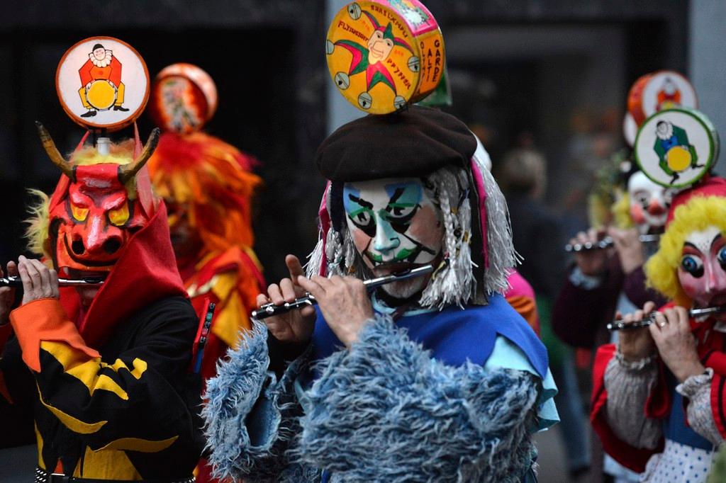 a costumed flute player at the Basel Morgestraich carival parade