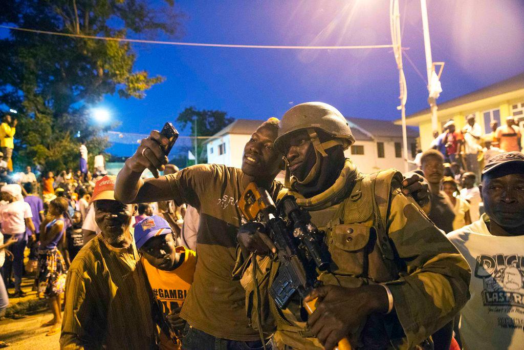 Crowd cheering peacekeepers in Gambia