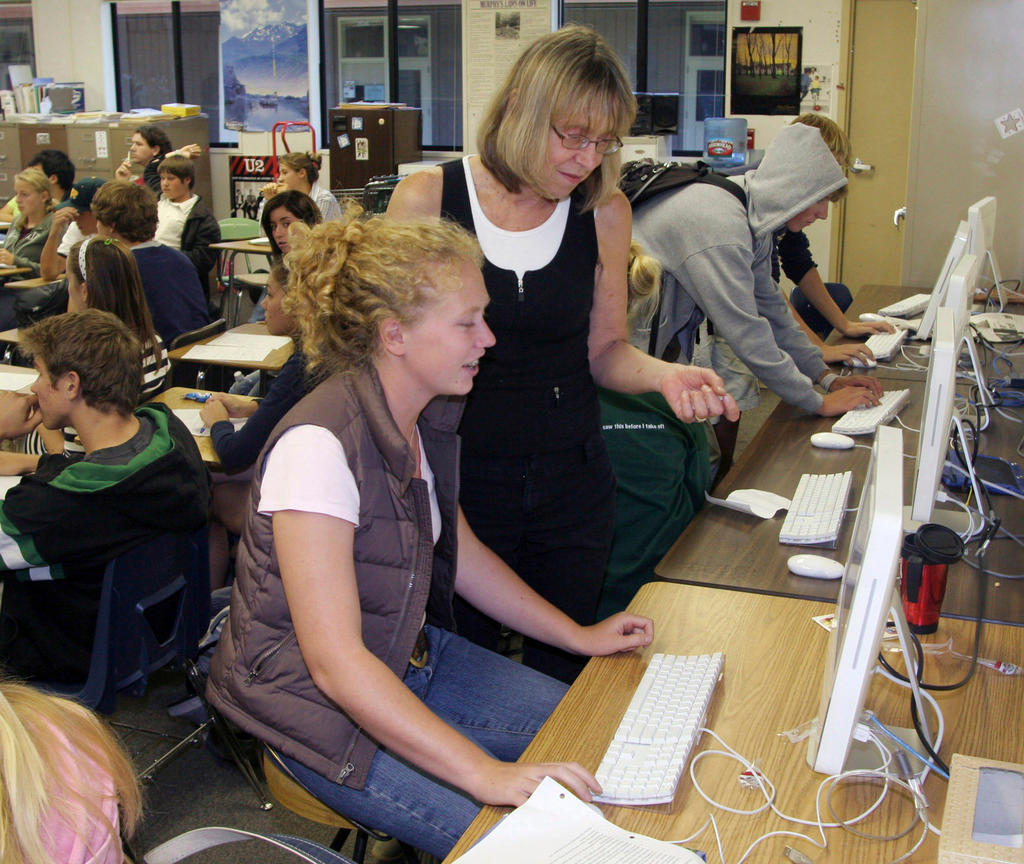 Classroom with students and teacher at computer