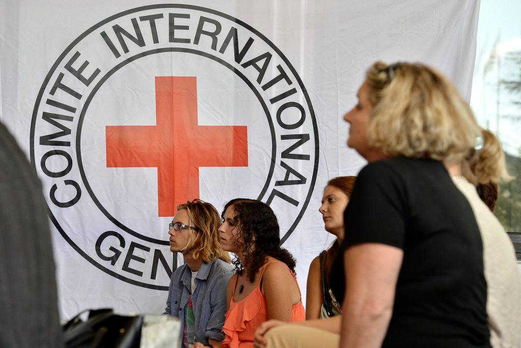ICRC logo on a banner and a group of women