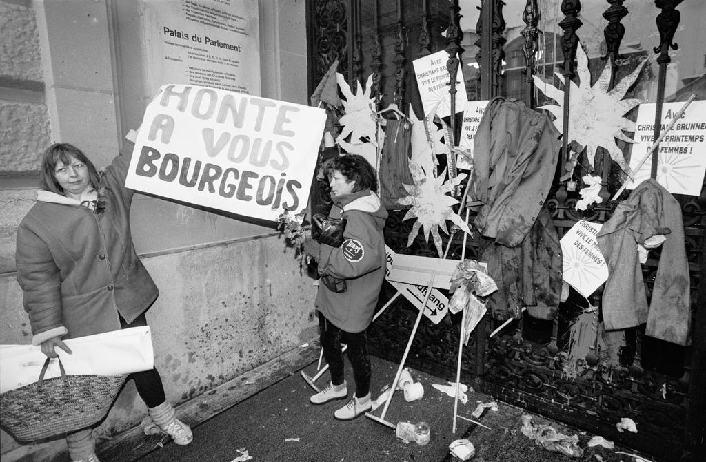 dos mujeres sostienen una pancarta de rechazo a los burgueses
