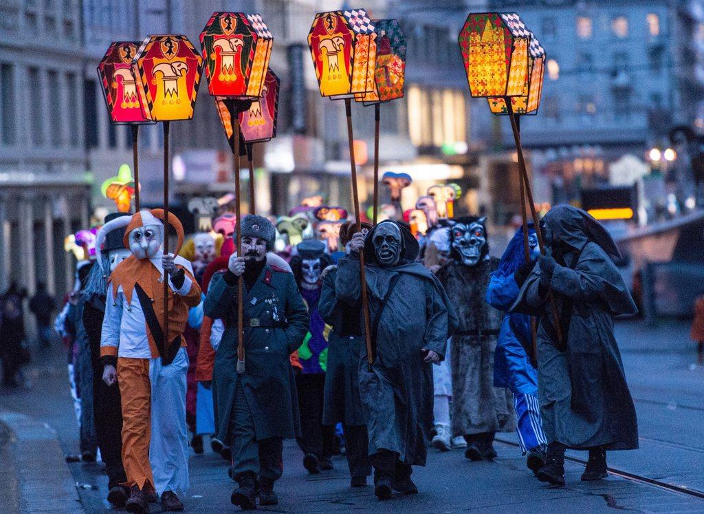 Revellers wearing lanterns parade through the streets during the carnival procession of Basel, Switzerland, 15 February 2016