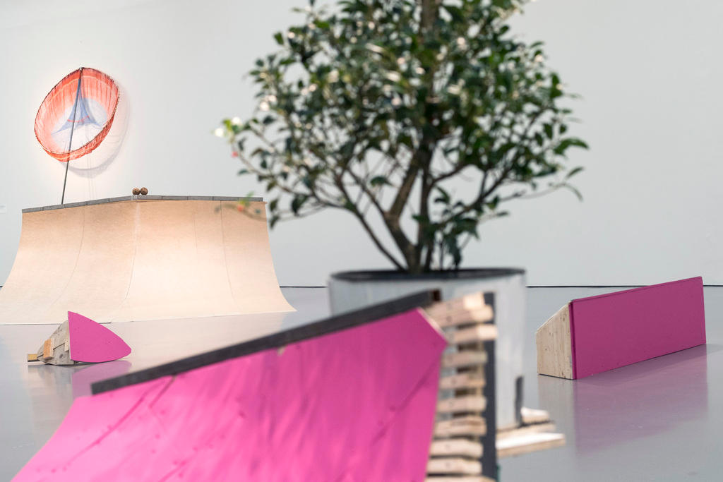 Kunstwerk mit Holzklotz in Pink, Baum und transparenter Wandinstallation
