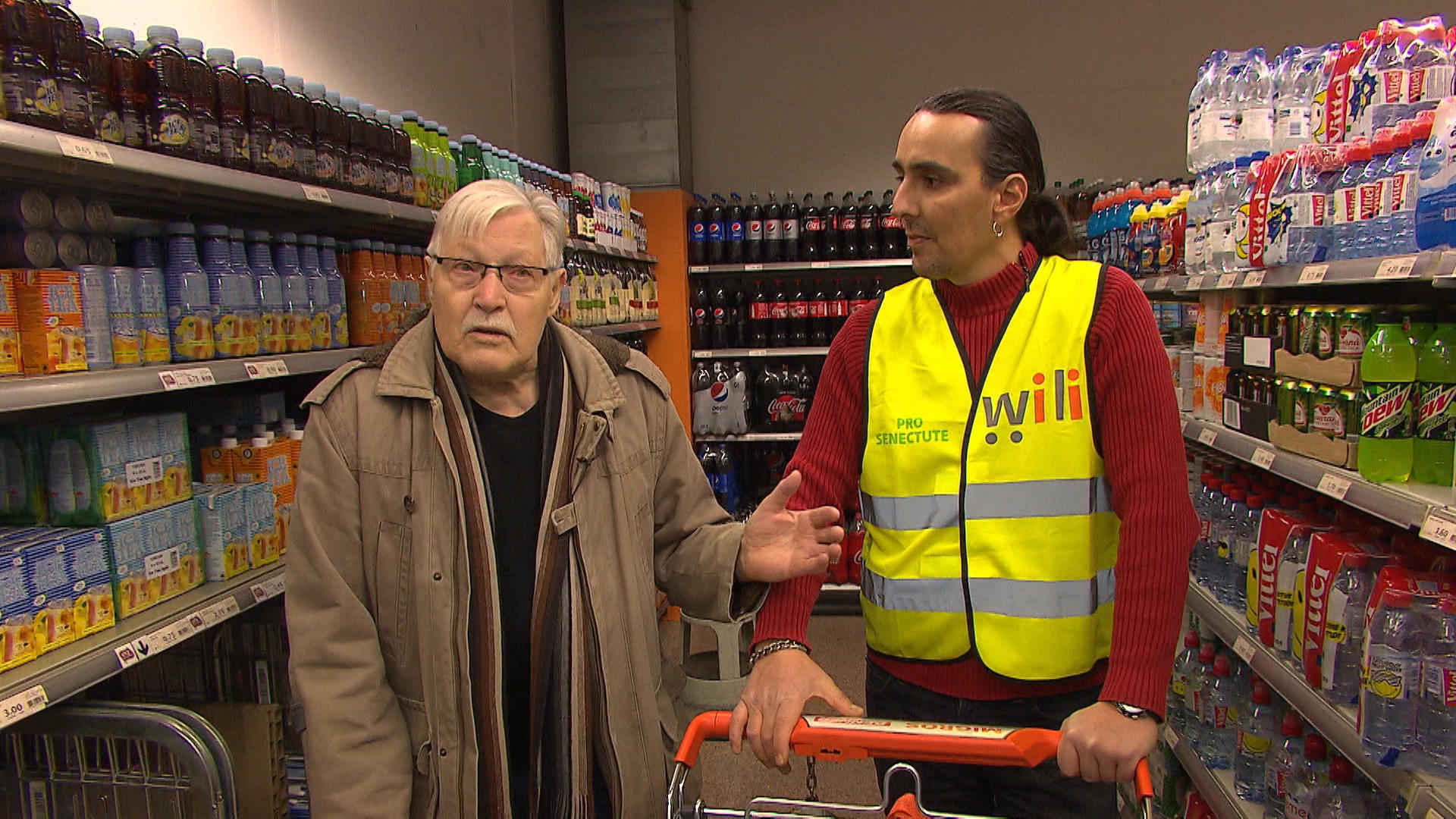 Younger man helps older man in shop