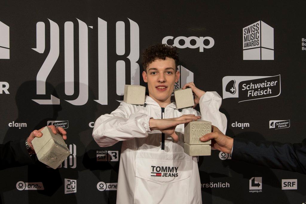 Nemo poses with his four awards after the ceremony of the 2018 Swiss Music Awards