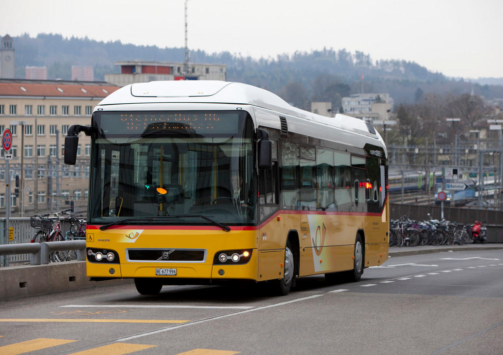 A PostBus drives through the Swiss capital, Bern