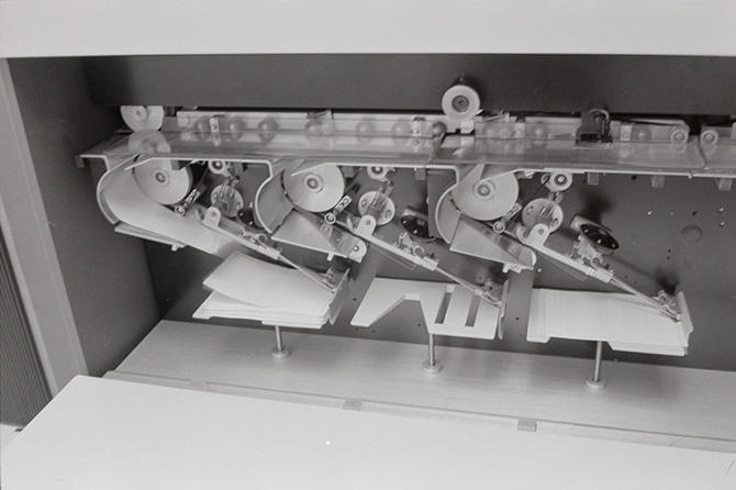 The insides of a computer. Paper is counted through the system of a computer