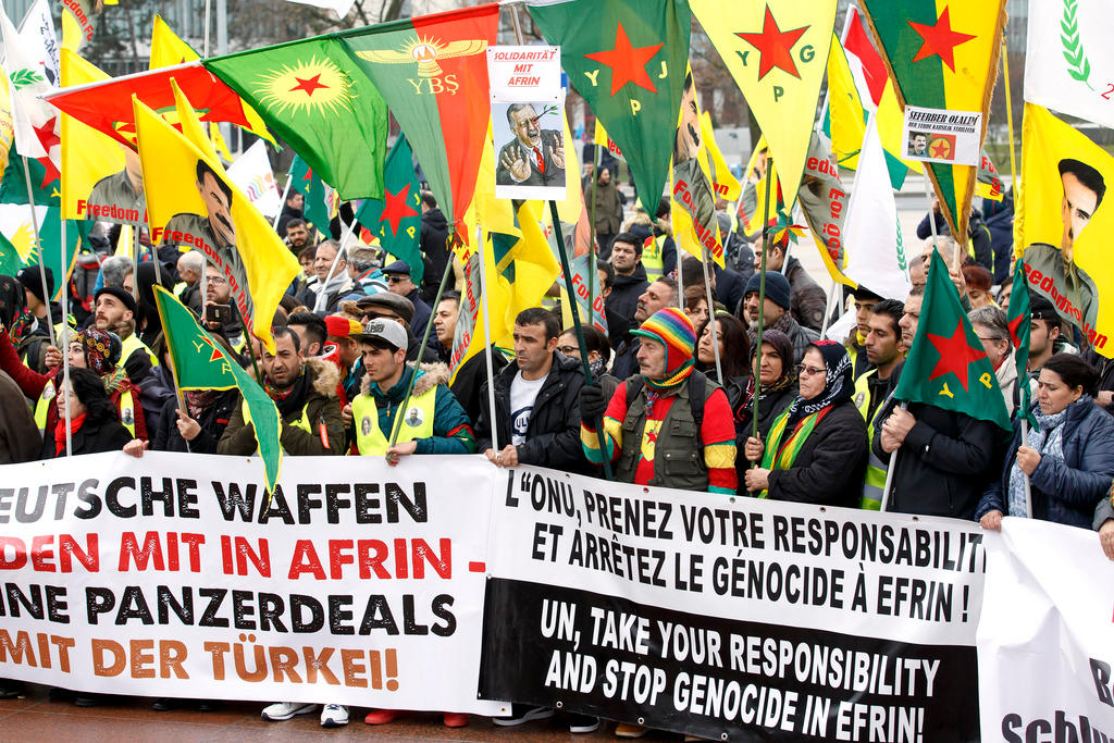 people demonstrating with colourful banners and flags