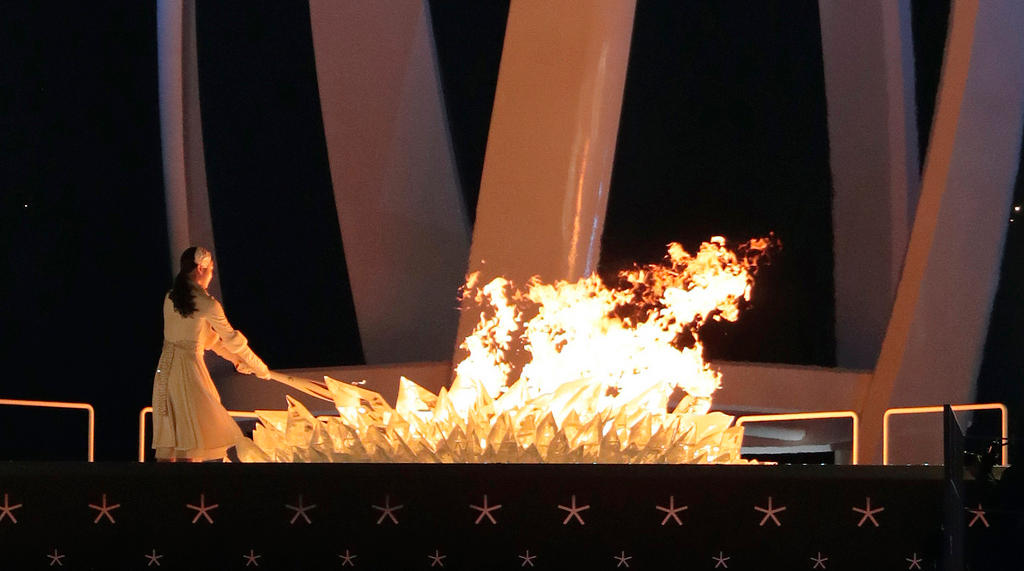 Yuna Kim, South Korean former Olympic champion, tries to warm things up by lighting the Olympic cauldron