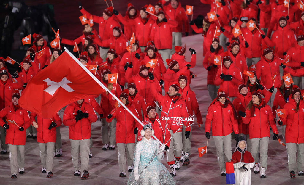 Dario Cologna carries the flag of Switzerland during the opening ceremony
