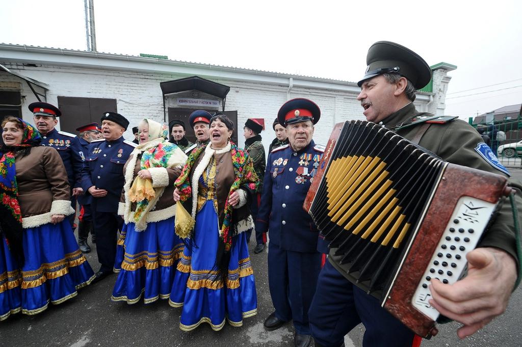 Men and women performing a traditional dance.