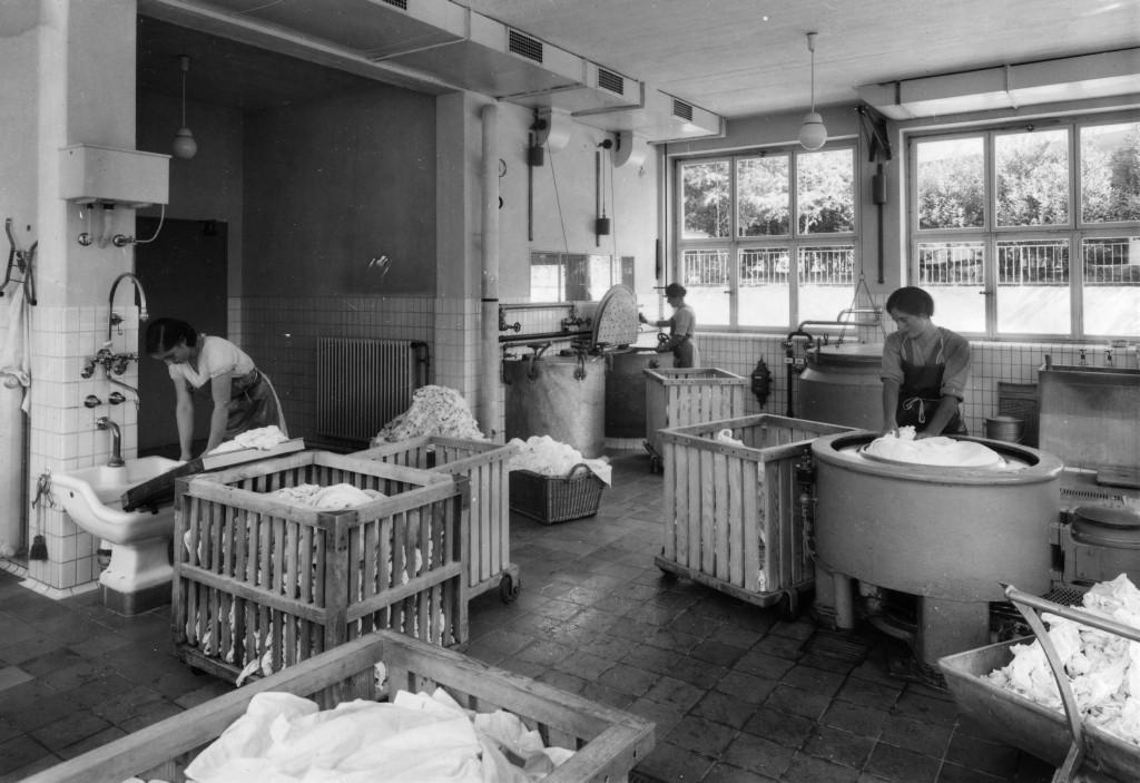 Women washing bed linen.