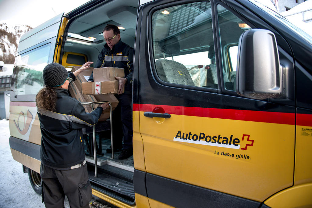 A picture of a yellow Swiss post bus