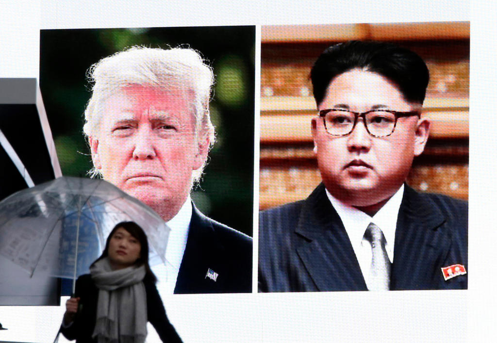 Screen showing US President Donald Trump, left, and North Korea s leader Kim Jong Un