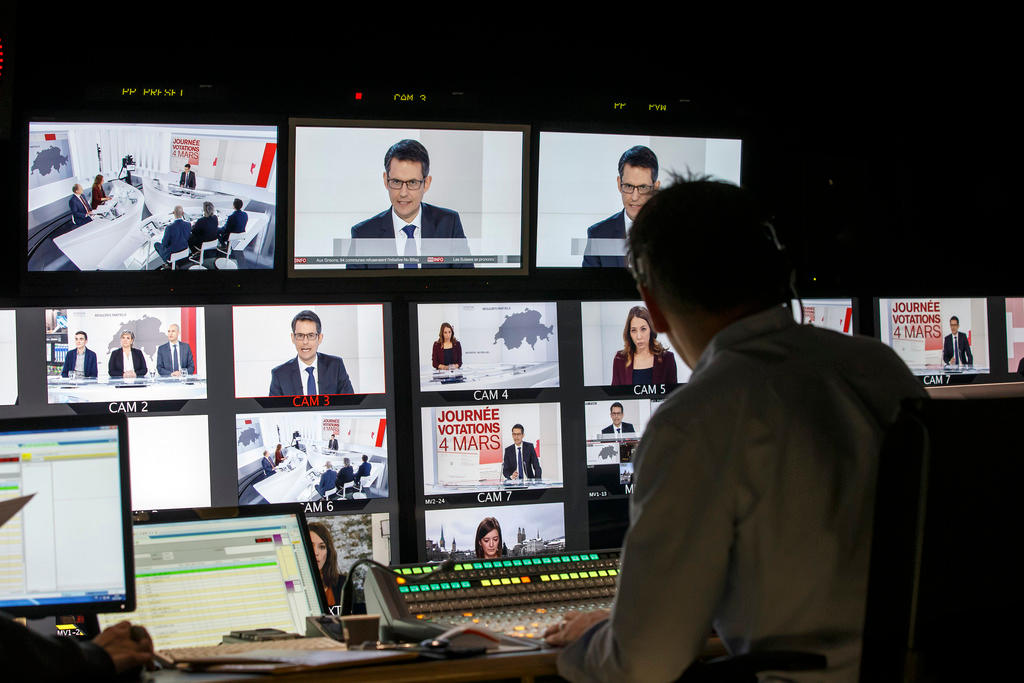Wall of television screens in a studio control room