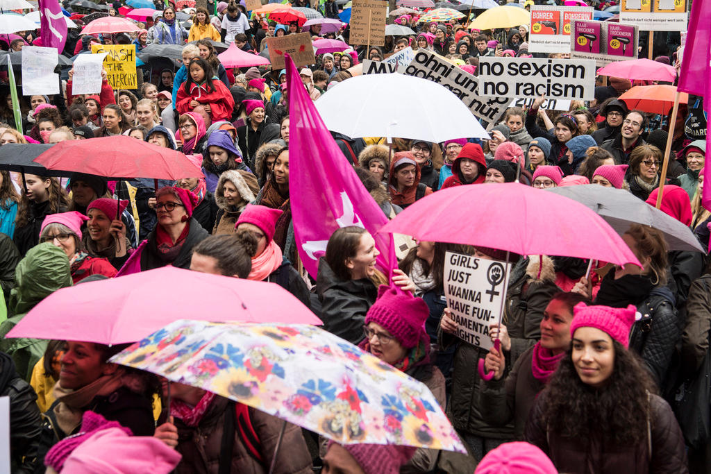 Some of the 8,000 protesters hold signs and umbrellas at the Women s March in the city of Zurich on Saturday, March 18, 2017.