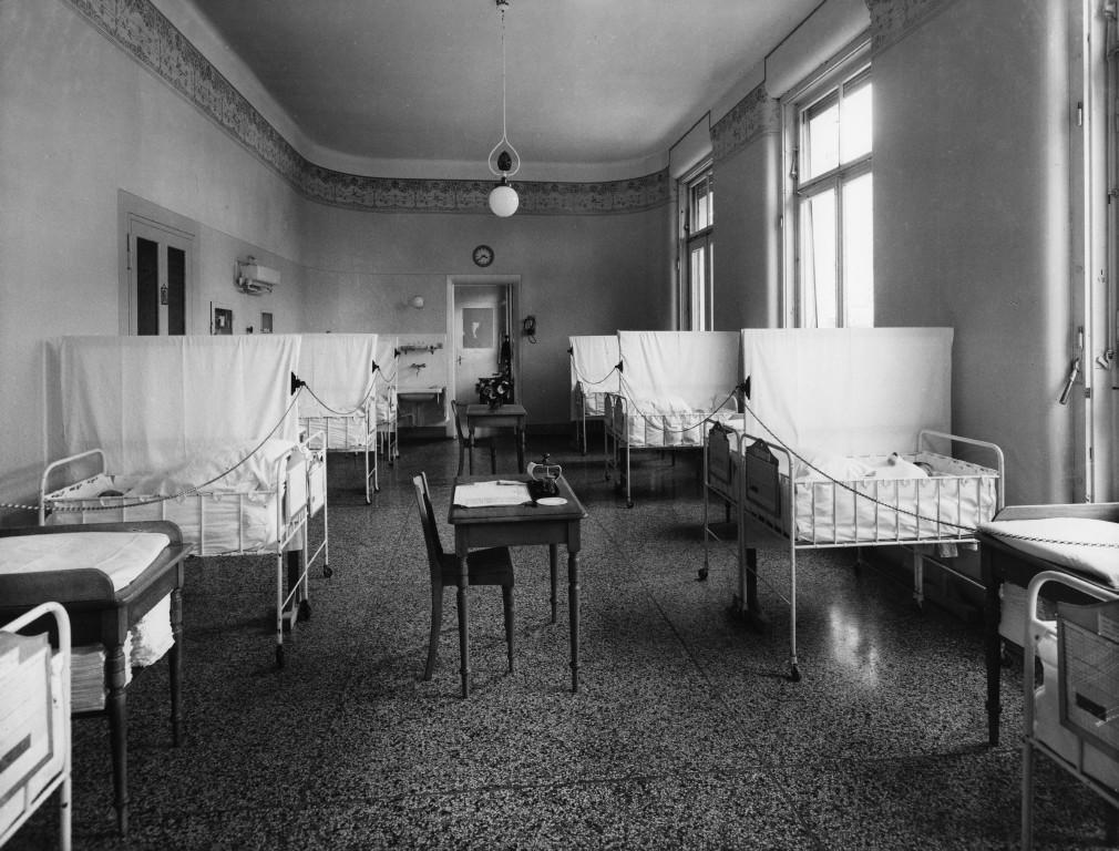 Una sala d ospedali con lettini per neonati.