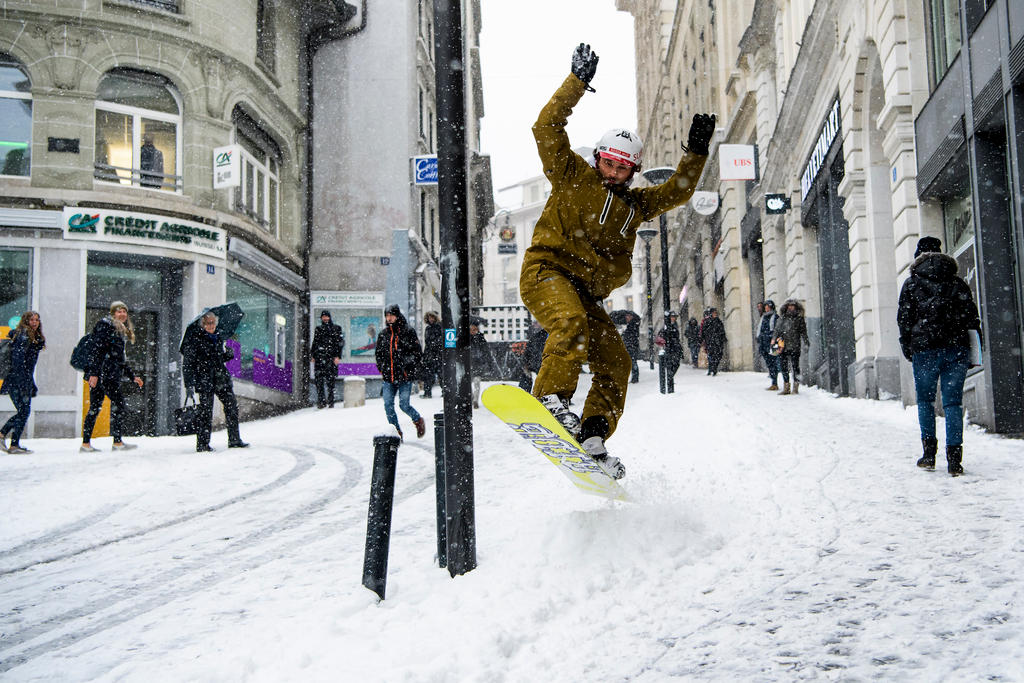 Snowboarding down a street in Lausanne