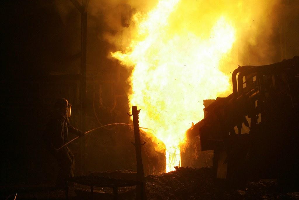 A factory worker pours molten iron at Hyundai-Steel Co in Dangjin, Chungcheongnam-do, South Korea