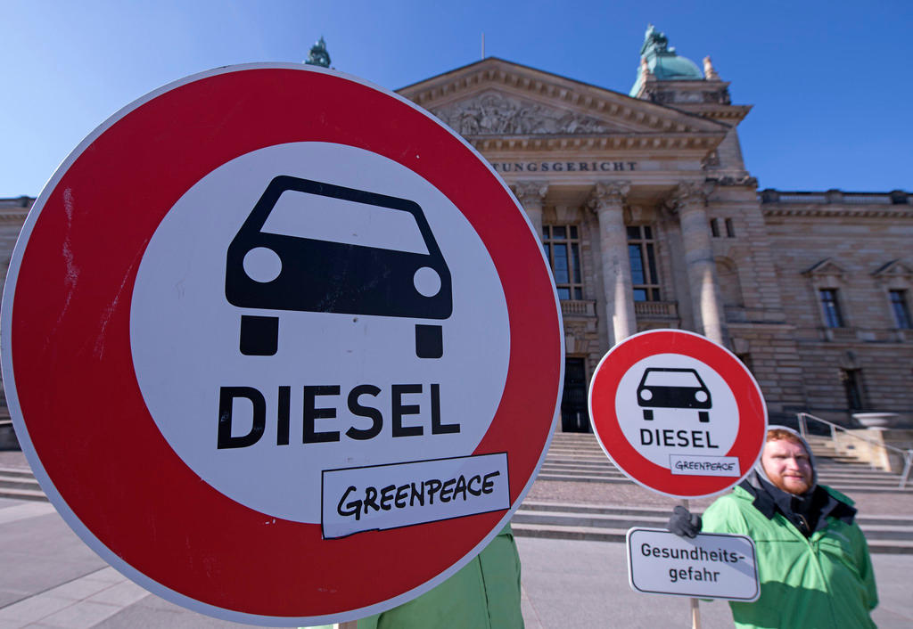 Activists with anti-diesel car signs