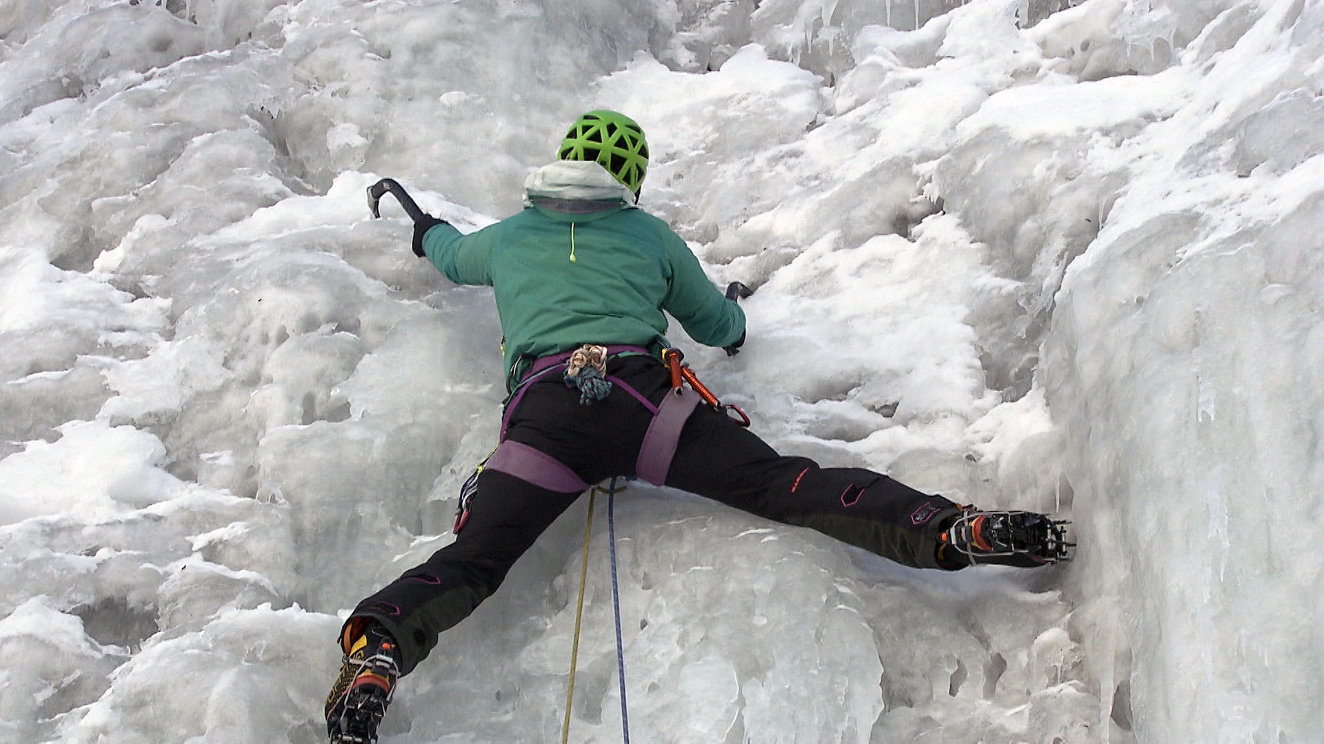 Person climbing an icy cliff