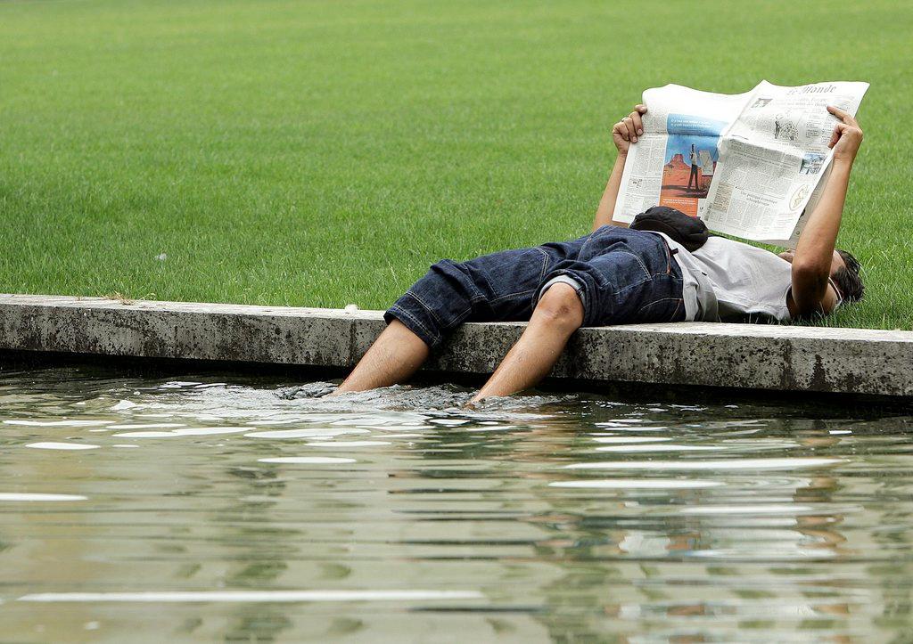 A picture of a young man reading a newspaper