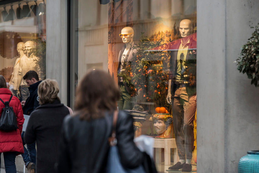 A picture of shoppers passing a shop window