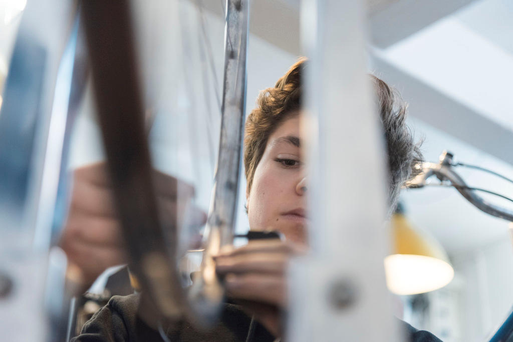 apprentice mending a bike