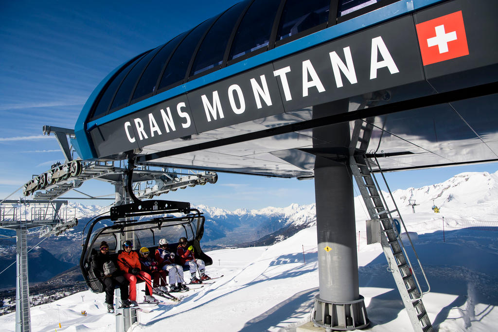 People on a ski lift in Crans Montana