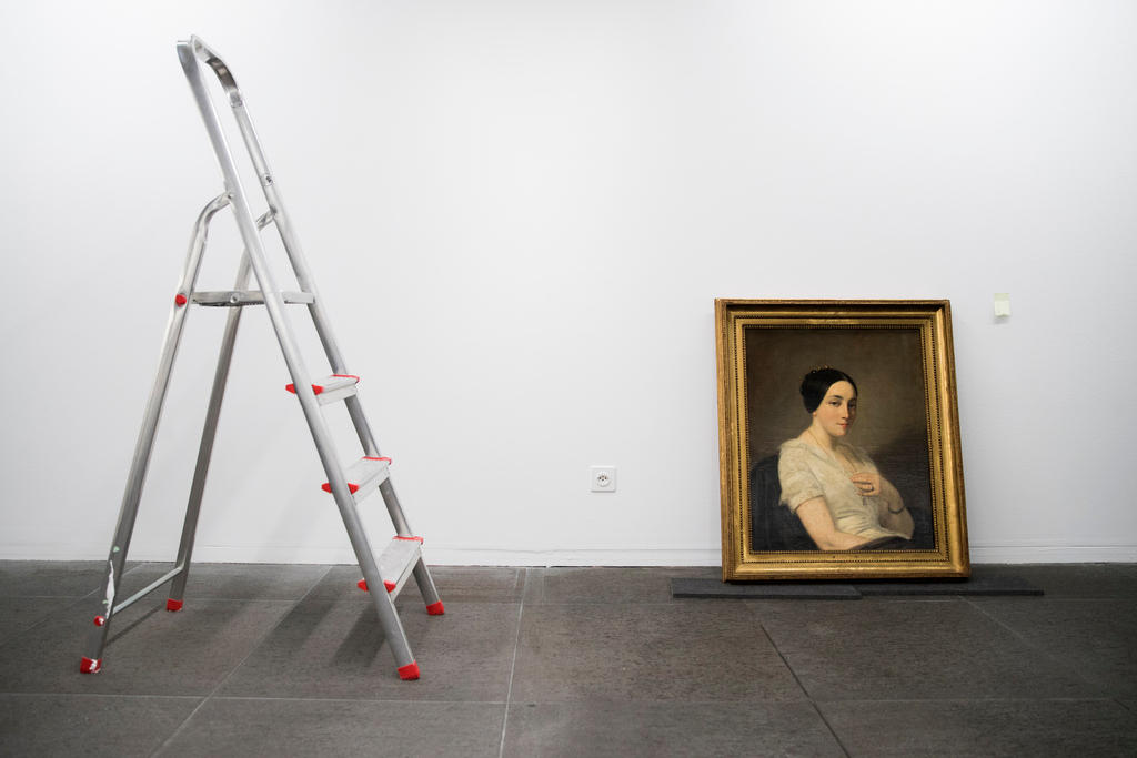 The painting Portrait einer jungen Frau leans against a wall, a open ladder stands to the left.