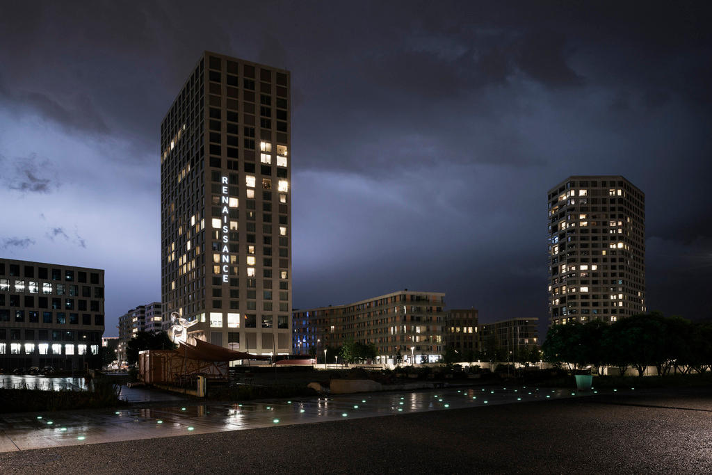 Night time scene of urban tower blocks lit up.