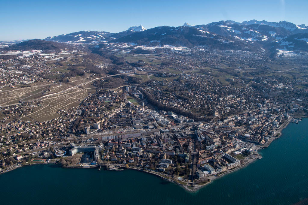 An aerial view of the town of Vevey by the lakeside and mountains in the background