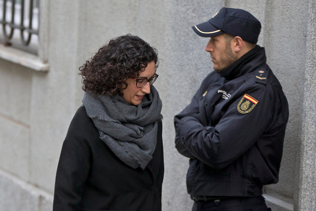 Marta Rovira pasa delante de un miembro de las fuerzas del orden