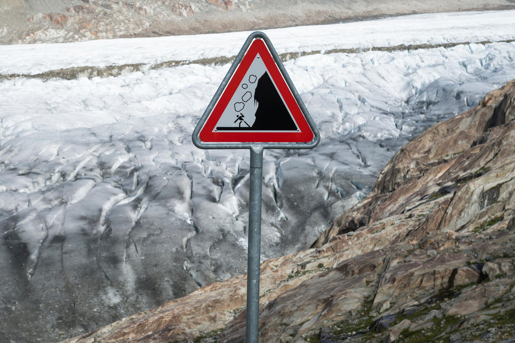 A danger falling rocks warning sign above the Aletsch glacier