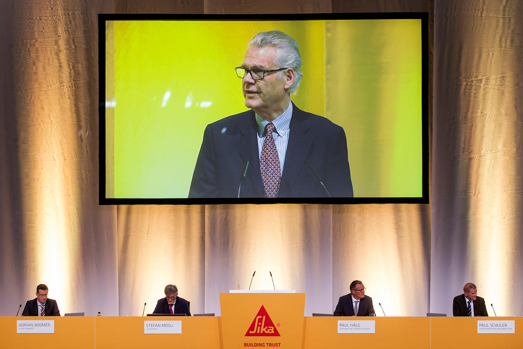 Urs Burkard appears on a screen at the Sika AGM