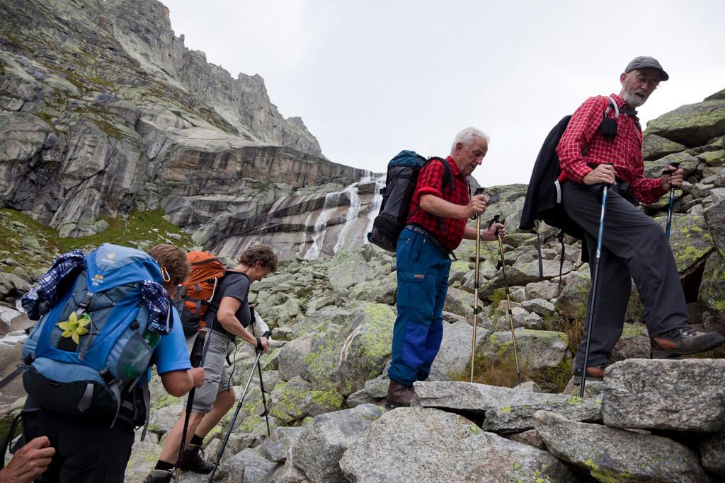 Personas mayores escalan una montaña