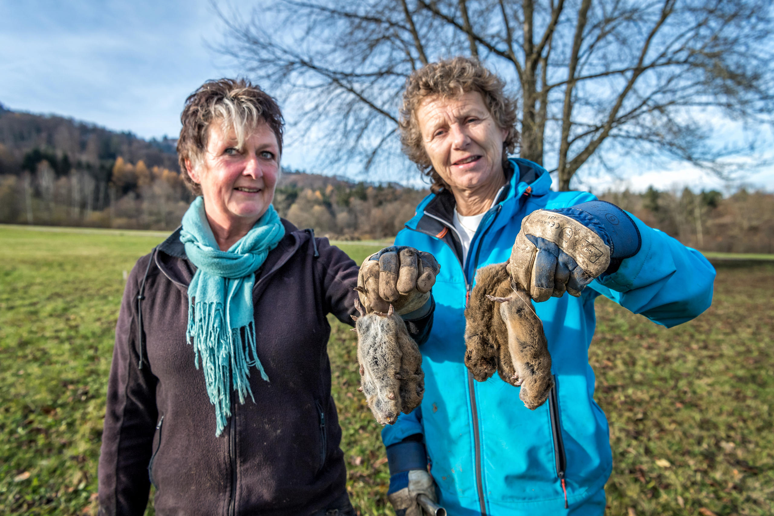 The women show their catch to the camera